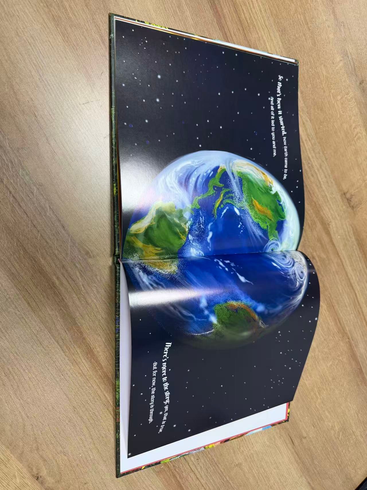 Full-color Earth illustration printed across a book spread