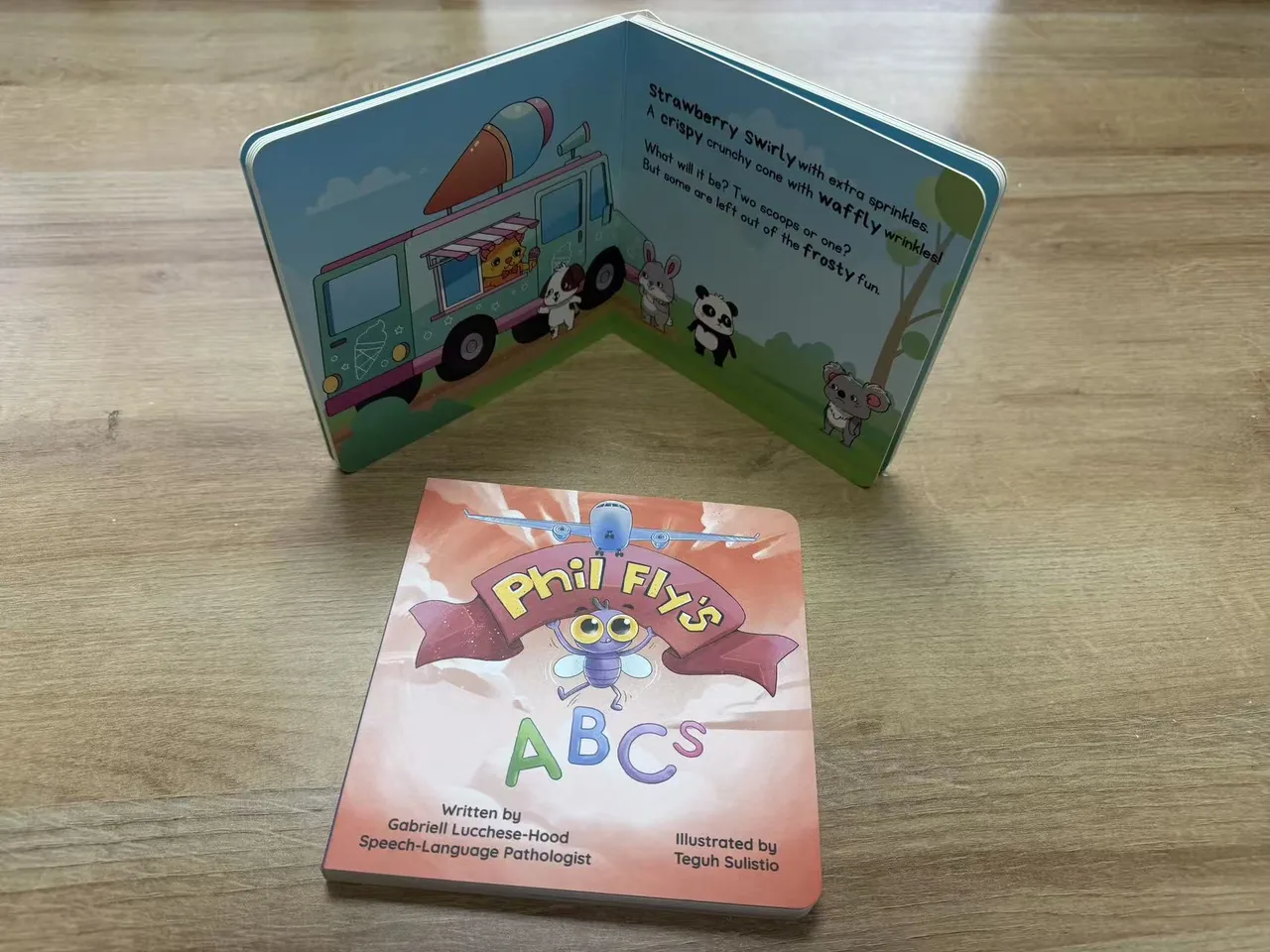 Children's book cover beside a full-color illustrated interior spread